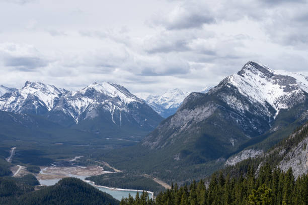 istock View on snowy mountain peaks and forest valley 1255763388