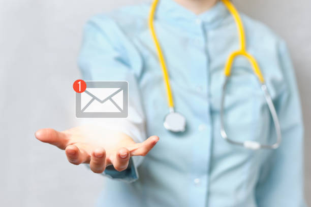 Doctor holds an abstract email with a hand in his hand stock photo