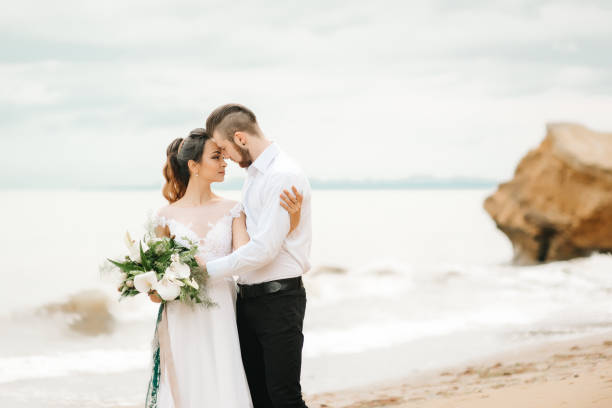 istock young couple groom with the bride on a sandy beach 1255763574