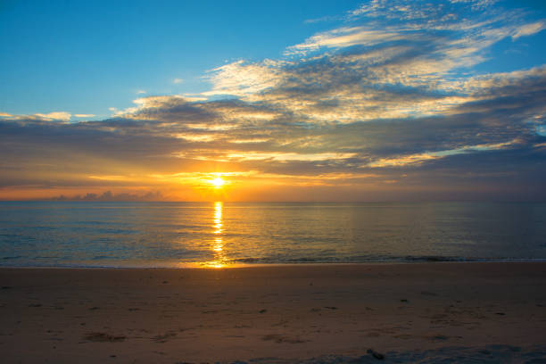 istock Colorful sea beach sunrise with deep blue sky and sun rays. 1255765576