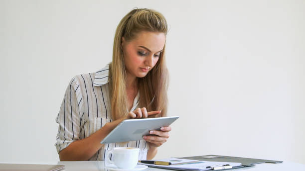 istock Blonde business woman working at modern office. 1255765585