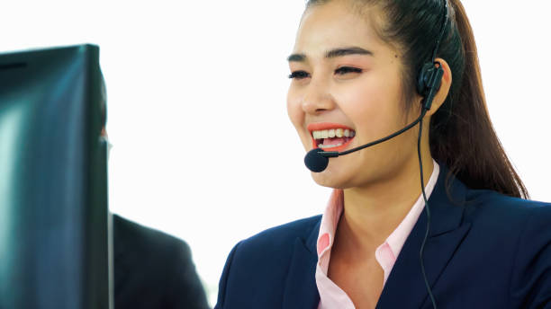 istock Business people wearing headset working in office 1255765878