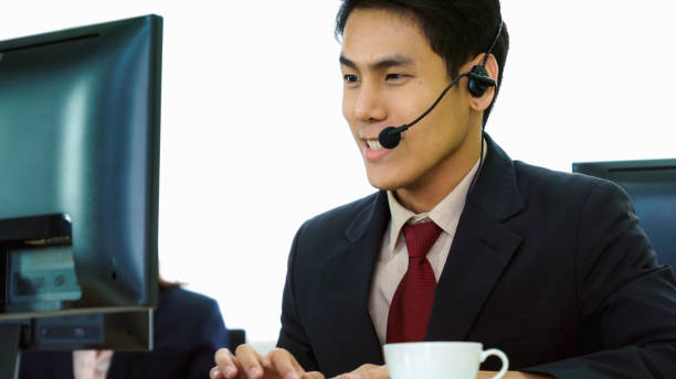 istock Business people wearing headset working in office 1255766410