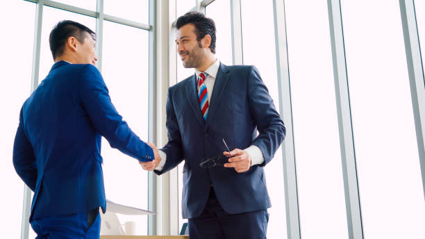 istock Business people handshake in corporate office 1255766583