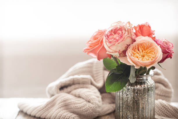 istock Cozy arrangement with roses on a wooden table 1255769160