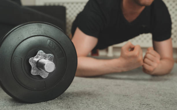 istock Man doing plank exercise. Home fitness training concept. 1255771948