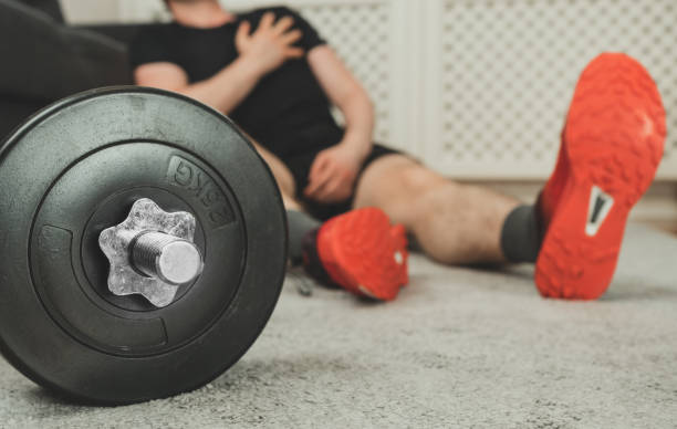 istock Man having heart attack. Home fitness training concept. 1255771955