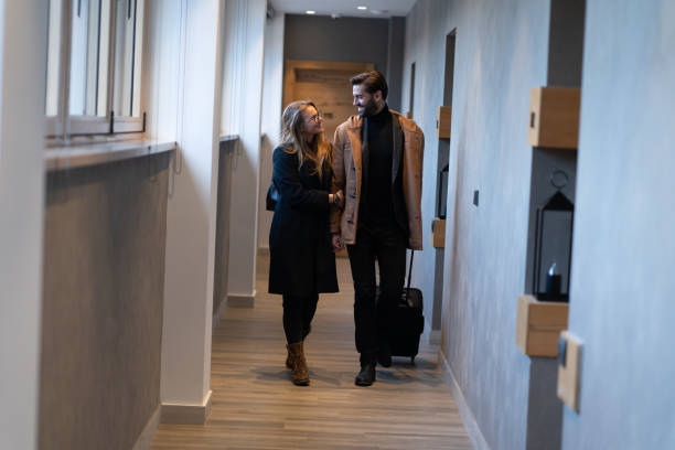istock Young well dressed couple arriving in hotel 1255772342