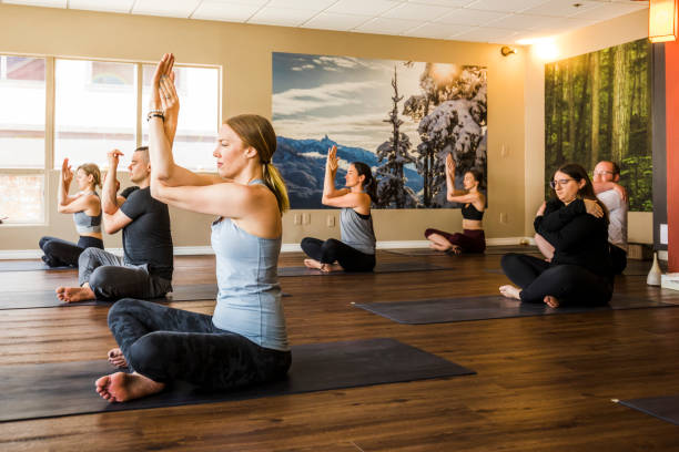 limited people yoga class in studio during covid-19 pandemic. - yoga meditating business group of people imagens e fotografias de stock