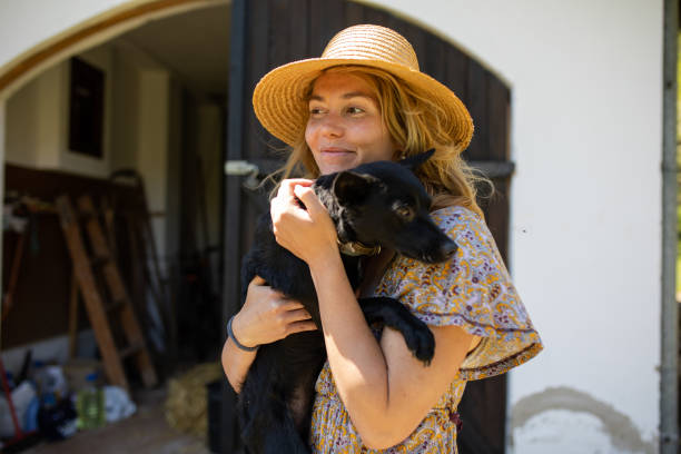 istock A woman smiling with a dog in her arms 1255773500