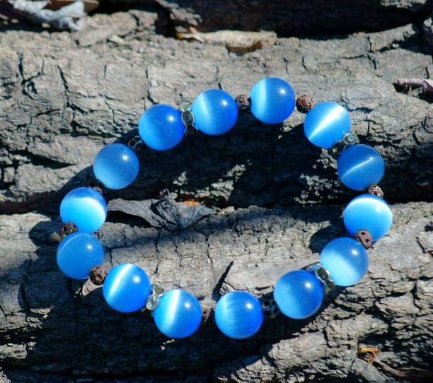 istock Blue necklace on a wooden background. 1255773572