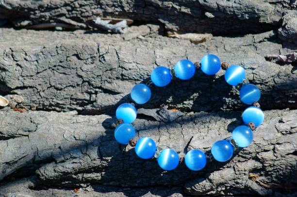 istock Blue necklace on a wooden background. 1255773589