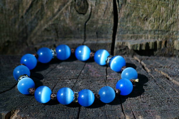 istock Blue necklace on a wooden background. 1255773636