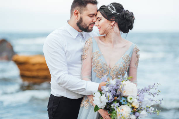 istock same couple with a bride in a blue dress walk 1255773790