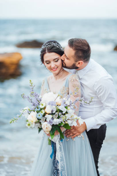 istock same couple with a bride in a blue dress walk 1255774511
