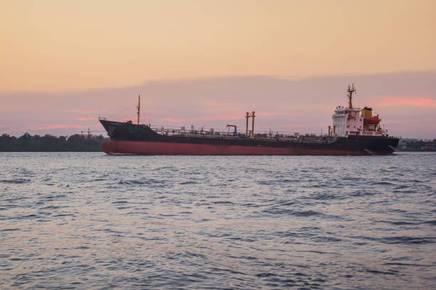 istock Massive container ship for import export and business logistic. Big cargo ship is leaving from Bangkok Port Authority of Thailand or Klong Toey port along Chao Phraya river in Bangkok,Thailand. 1255774515
