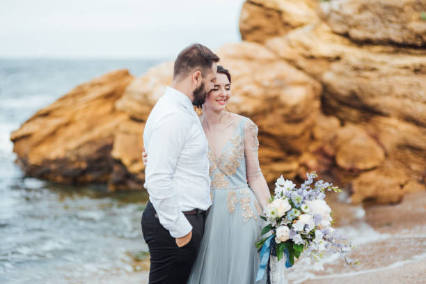 istock same couple with a bride in a blue dress walk 1255774543