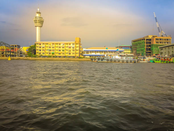 istock Riverfront view of Samut Prakan city hall with new observation tower and boat pier. Samut Prakan is at the mouth of the Chao Phraya River on Gulf of Thailand. 1255774828