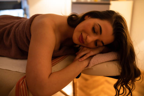 istock A woman smiling while lying on a massage table 1255775602