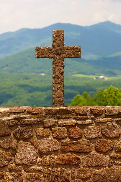 Photo of Stone cross against mountain background