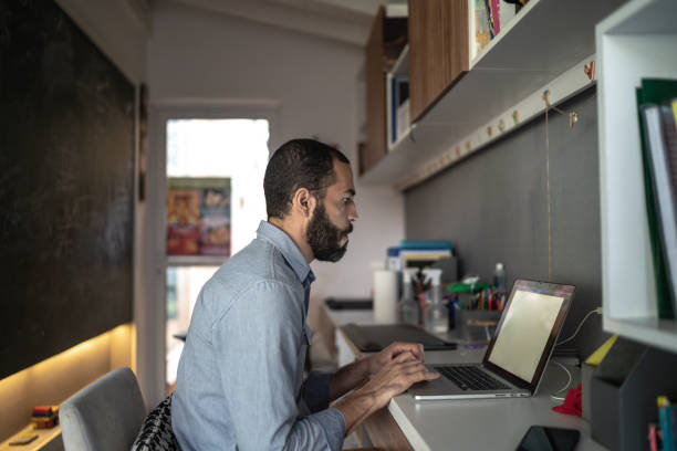 istock Profile view of a man working at home 1255777027