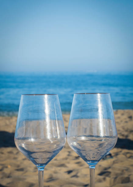 istock Wine glasses in the sand 1255779374