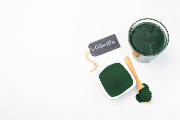 istock Superfood chlorella in powder and as drink, horizontal, copy space, top view 1255782527