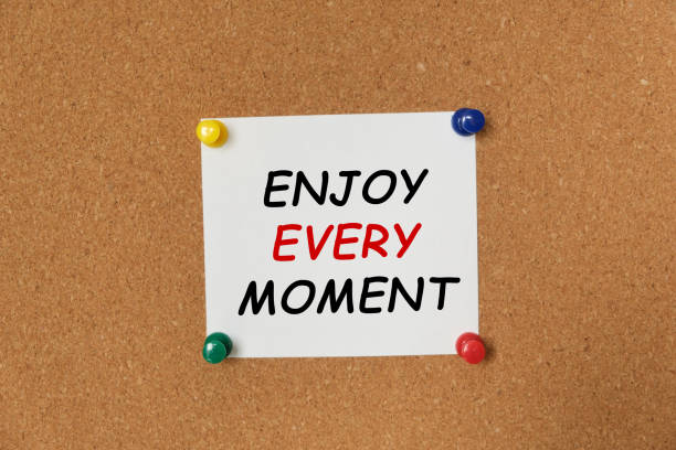 istock Text ENJOY EVERY MOMENT written on a sticker 1255786109