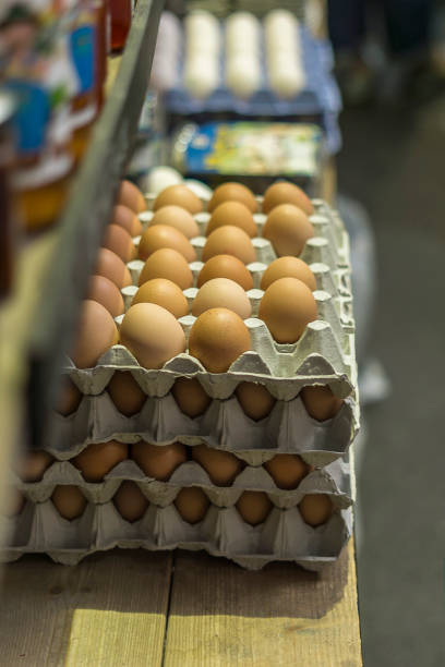 Stacked egg cartons for sale at market