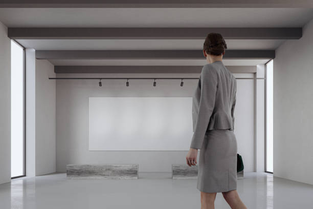 istock Art gallery with woman walking 1255788192