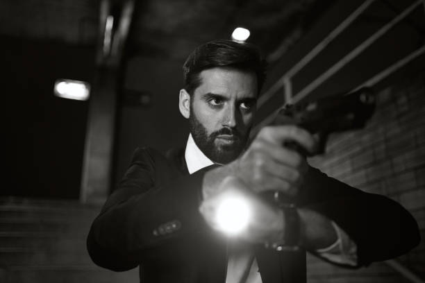 istock Serious inspector observing a possible crime scene with a flashlight 1255788419