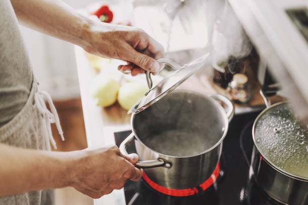 istock Man cooking fresh food at home 1255789543