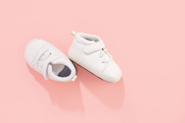 istock Baby shoes on pink background 1255789975