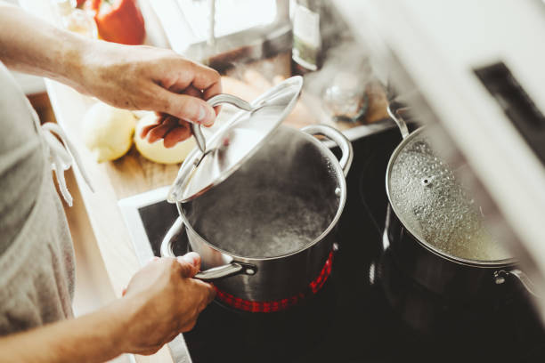 istock Man cooking fresh food at home 1255790257