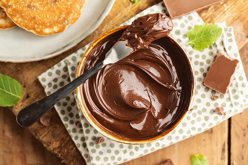 Tasty appetizing freshmade chocolate paste served in bowl for breakfast. Closeup