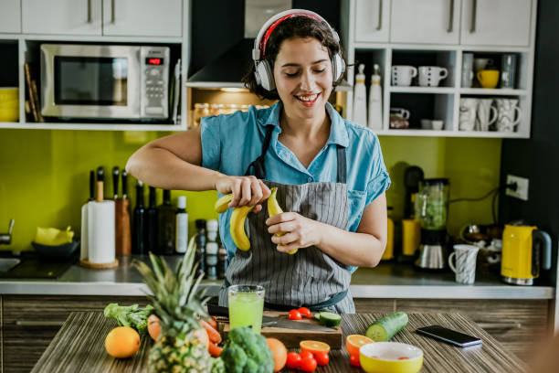 istock Young woman in the kitchen having fun 1255791553