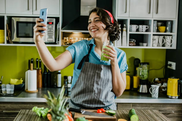 istock Young woman taking a selfie with fresh smoothie 1255791599