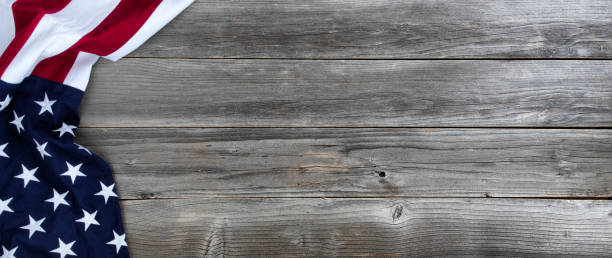 istock Waving US flag on weathered wooden background 1255792965