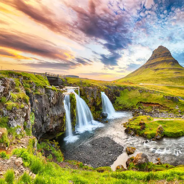 Dramatic view on Kirkjufellsfoss waterfall  near Kirkjufell mountain at sunset.  Location: Kirkjufellsfoss, Grundarfjordurn, Iceland, Europe