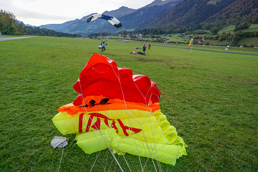 Young man flying with colorful paraglider. extreme sport