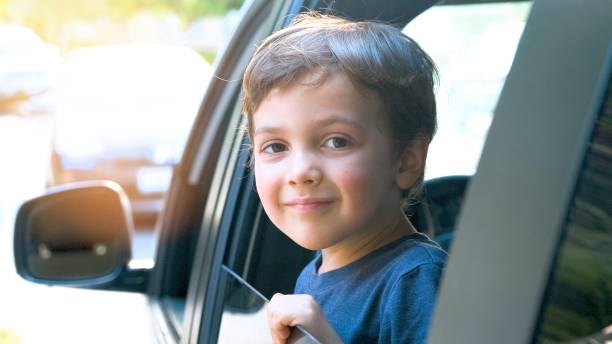 istock Smiling little boy looking through a vehicle window 1255799926