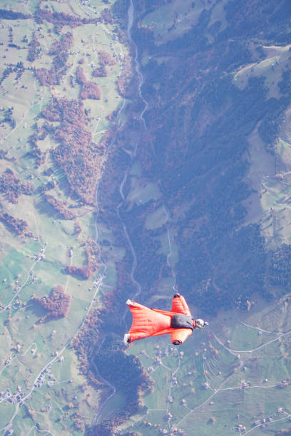 istock Wingsuit flier soars over Swiss Alps 1255800865