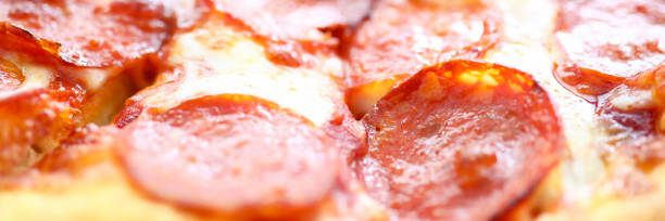 Fresh baked pizza with crusty cheese and hot tasty pepperoni ready to eat