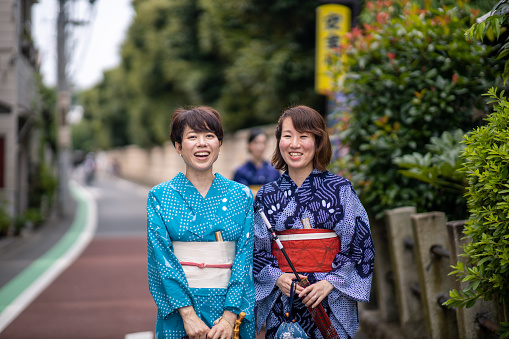 Portrait of Japanese women in yukata standing on street