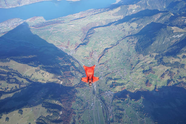 istock Wingsuit flier soars over Swiss Alps 1255802503