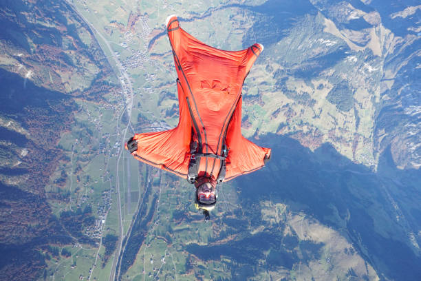 istock Wingsuit flier soars over Swiss Alps 1255802771