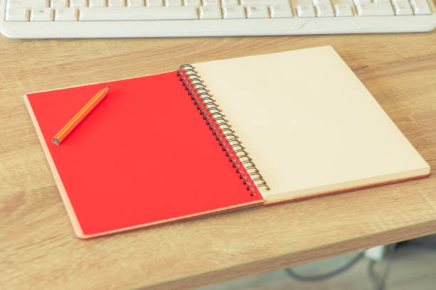 istock office notebook red white paper color and pencil table textured surface with empty copy space for your text here, advertising concept 1255802775