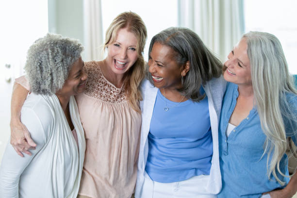 istock Senior friends talking and laughing together 1255802810