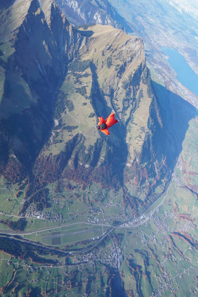 istock Wingsuit flier soars over Swiss Alps 1255804404