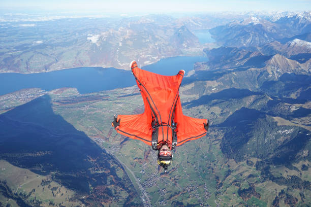 istock Wingsuit flier soars over Swiss Alps 1255804499
